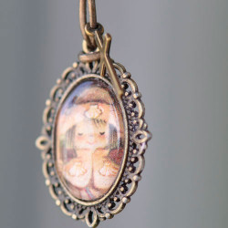 Medallita bronce ovalada con cristal lupa13x18 mm. Imagen "Apóstol Santiago".